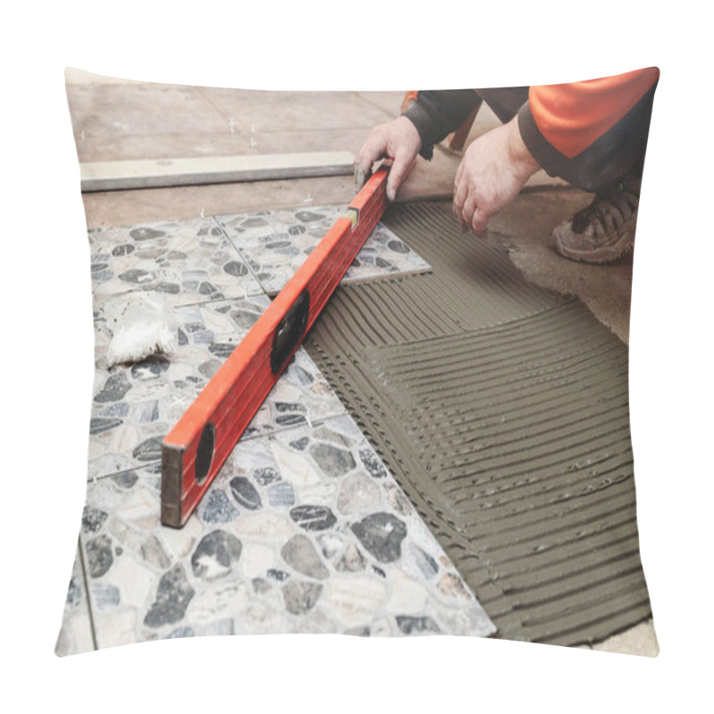 Personality  Laying Floor Ceramic Tile. Construction Worker Laying Tiles Over Concrete Floor Using Tile Levelers, Notched Trowels And Tile Mortar. Renovating The Floor.  Pillow Covers