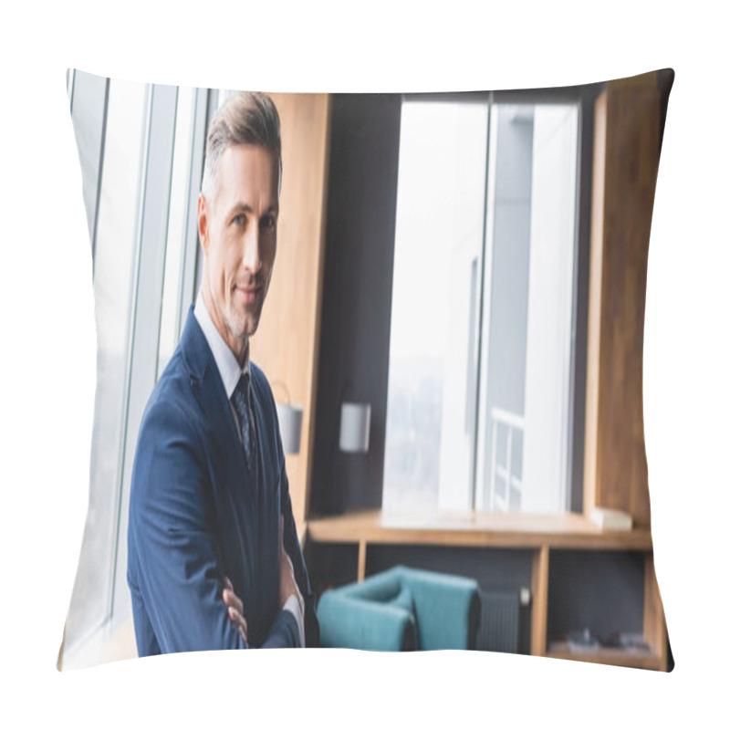 Personality  Panoramic Shot Of Smiling Businessman In Suit With Crossed Arms Looking At Camera In Hotel  Pillow Covers