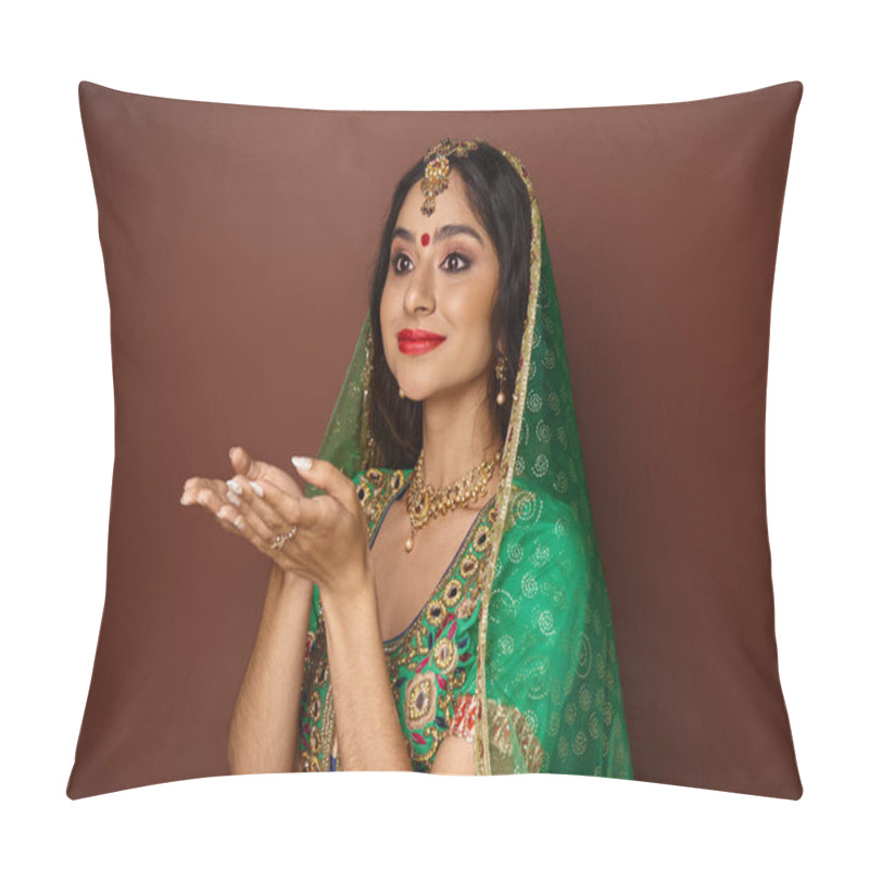 Personality  beautiful young indian woman in traditional clothes posing with open palms and looking away pillow covers