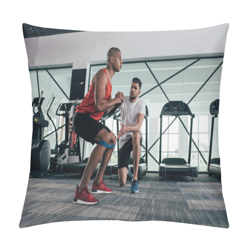 Personality  Attentive Trainer Looking At Young African American Sportsman Warming Up In Gym Pillow Covers