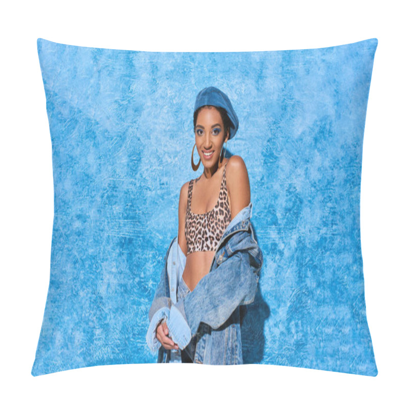 Personality  Fashionable African American Woman In Beret And Top With Animal Print Smiling At Camera And Posing In Denim Jacket On Blue Textured Background, Stylish Denim Attire Pillow Covers