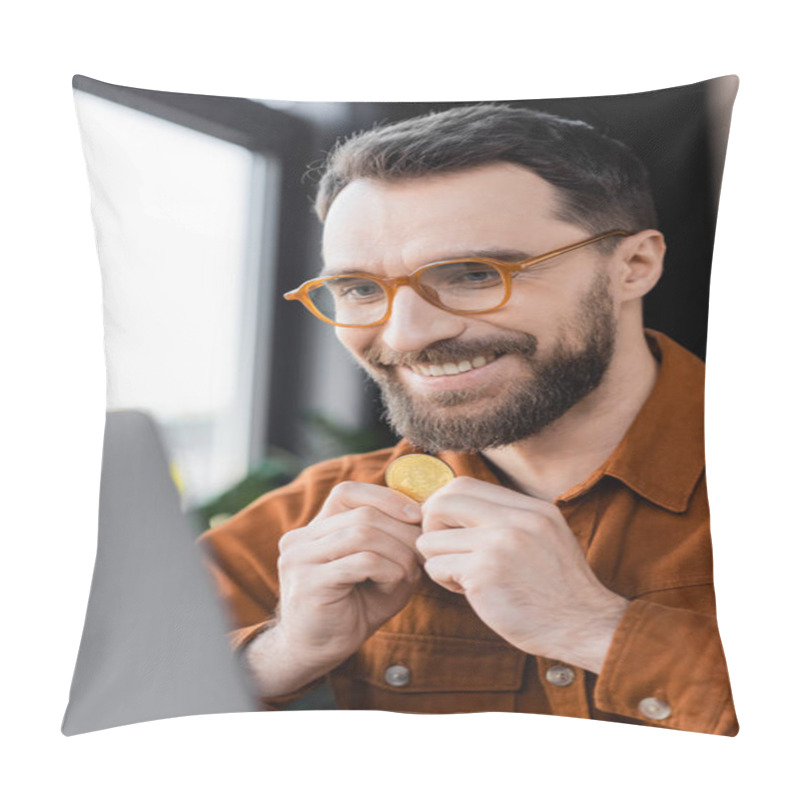 Personality  KYIV, UKRAINE - OCTOBER 18, 2022: Pleased And Bearded Businessman In Stylish Eyeglasses And Shirt Holding Golden Bitcoin And Smiling While Looking At Laptop On Blurred Foreground In Office Pillow Covers