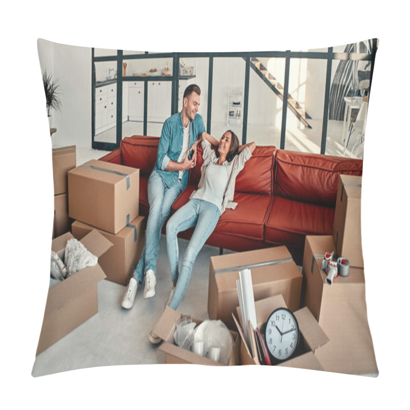 Personality  Young Married Couple Sitting On The Sofa In The Living Room At Home. Happy Husband And Wife Are Having Fun, Are Looking Forward To A New Home. Moving And Relocate New Home Concept. Pillow Covers