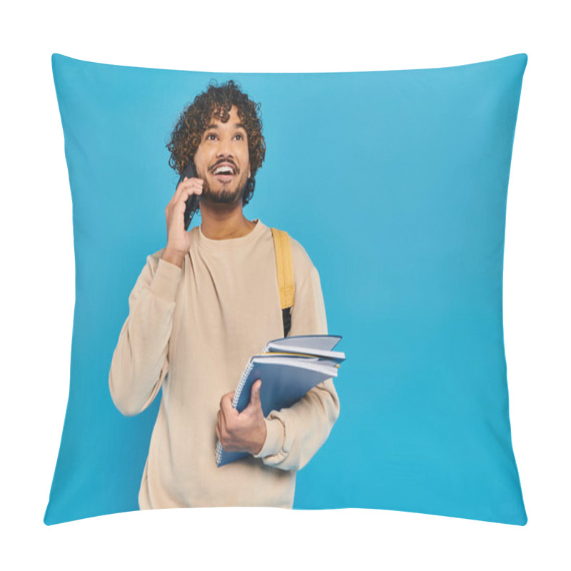 Personality  An Indian Student In Casual Attire Stands Against A Blue Backdrop, Holding A Folder And Talking On A Cell Phone. Pillow Covers