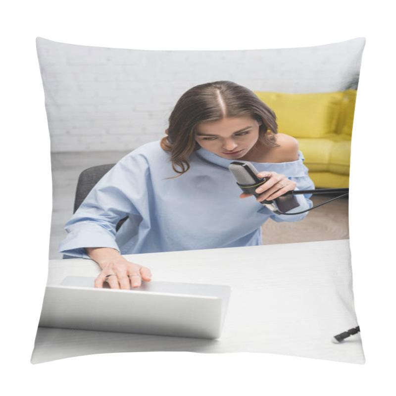 Personality  Brunette Broadcaster In Blue Blouse Talking At Microphone And Using Blurred Laptop While Sitting Near Table During Online Stream In Podcast Studio With Yellow Sofa On Blurred Background  Pillow Covers