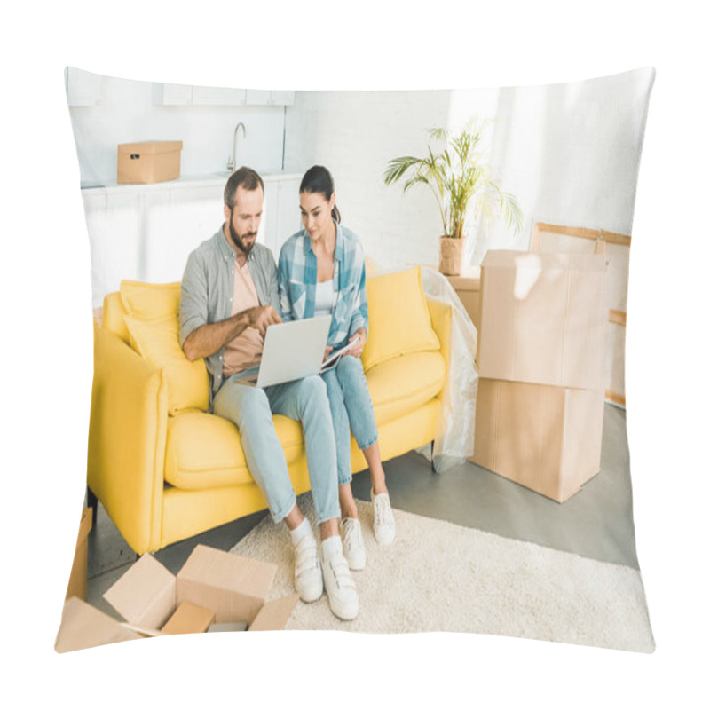 Personality  Focused Couple Sitting On Couch, Using Laptop And Planning Relocation To New House, Moving Concept Pillow Covers