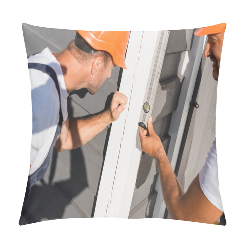 Personality  Selective Focus Of Builders Looking At Spirit Level While Working With Facade Of House  Pillow Covers