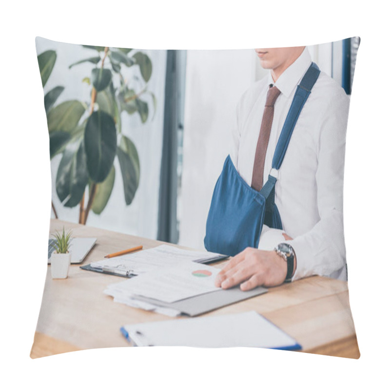 Personality  Cropped View Of Worker With Broken Arm In Bandage Sitting At Table And Reading Documents In Office, Compensation Concept Pillow Covers