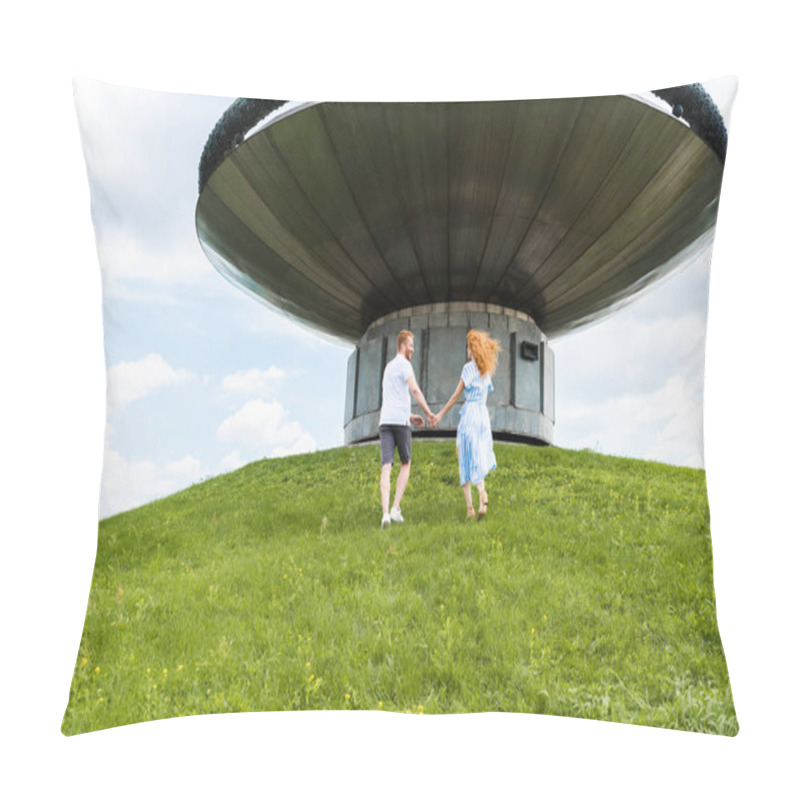 Personality  Rear View Of Redhead Couple Holding Hands And Walking On Grassy Hill In Front Of Modern Building  Pillow Covers