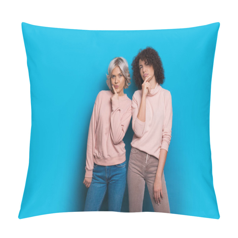 Personality  Two Caucasian Sisters Dressed In Pink Sweaters And Jeans Are Looking Thoughtful Posing On A Blue Background Pillow Covers