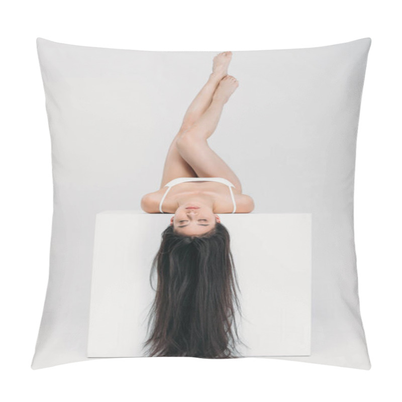 Personality  Brunette Asian Girl Lying On White Cube, Isolated On Grey  Pillow Covers