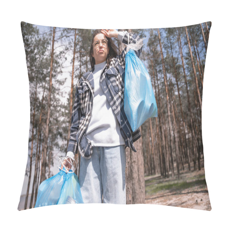 Personality  Displeased Young Woman In Glasses Holding Blue Trash Bags In Forest  Pillow Covers