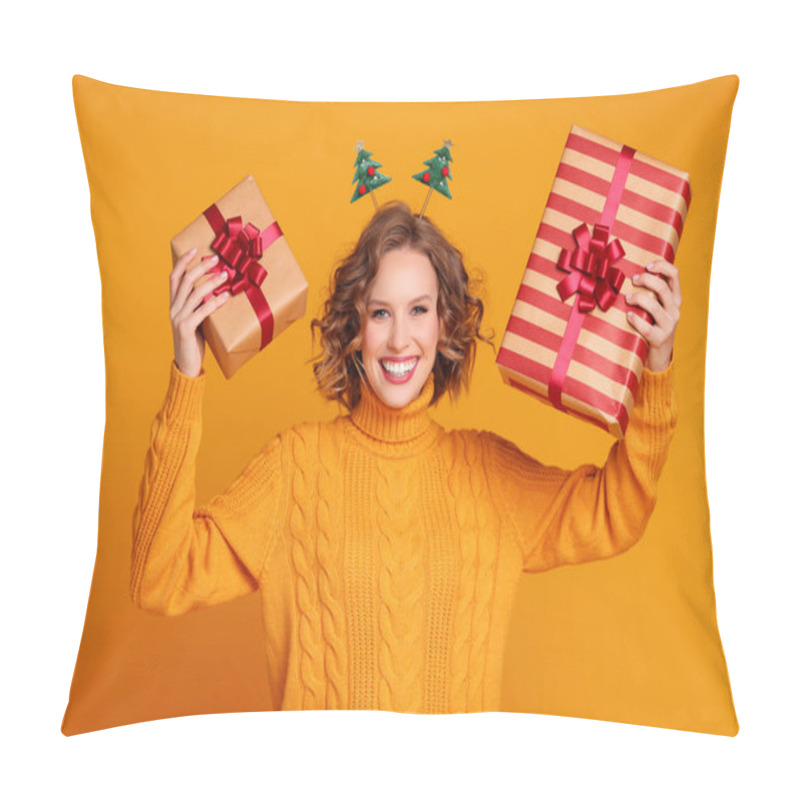 Personality  Happy Young Woman In Sweater And Headband Showing Wrapped Gifts And Looking At Camera With Smile On Christmas Day Against Yellow Backgroun Pillow Covers