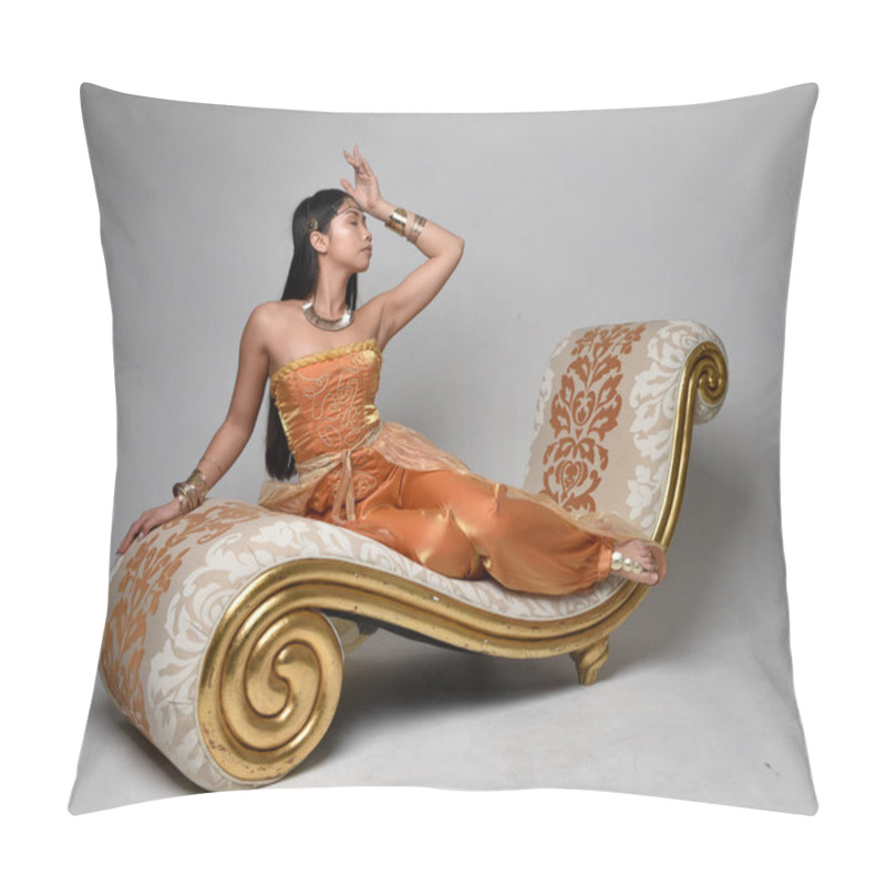 Personality  Full Length Portrait Of Pretty Young Asian Woman Wearing Golden Arabian Robes Like A Genie, Seated Pose On Lounge, Isolated On Studio Background. Pillow Covers