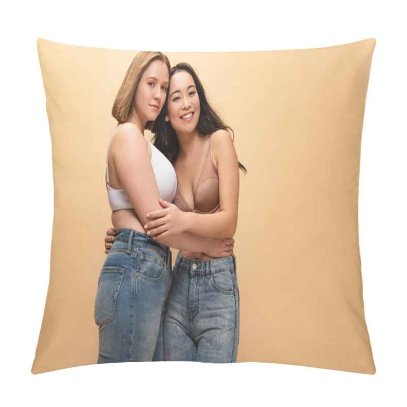 Personality  Pensive Overweight Young Woman And Smiling Slim Asian Girl Hugging While Looking At Camera Isolated On Beige, Body Positivity Concept Pillow Covers