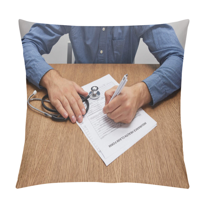 Personality  Cropped Shot Of Person Holding Stethoscope And Signing Insurance Form At Wooden Table  Pillow Covers