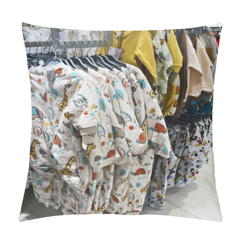 Personality  Kyiv, Ukraine - December 18, 2024: A Neatly Organized Clothing Display In A Retail Shop Showcasing Children's Outfits With Colorful Animal-themed Prints, Emphasizing Vibrant Designs Suitable For Kids. Pillow Covers