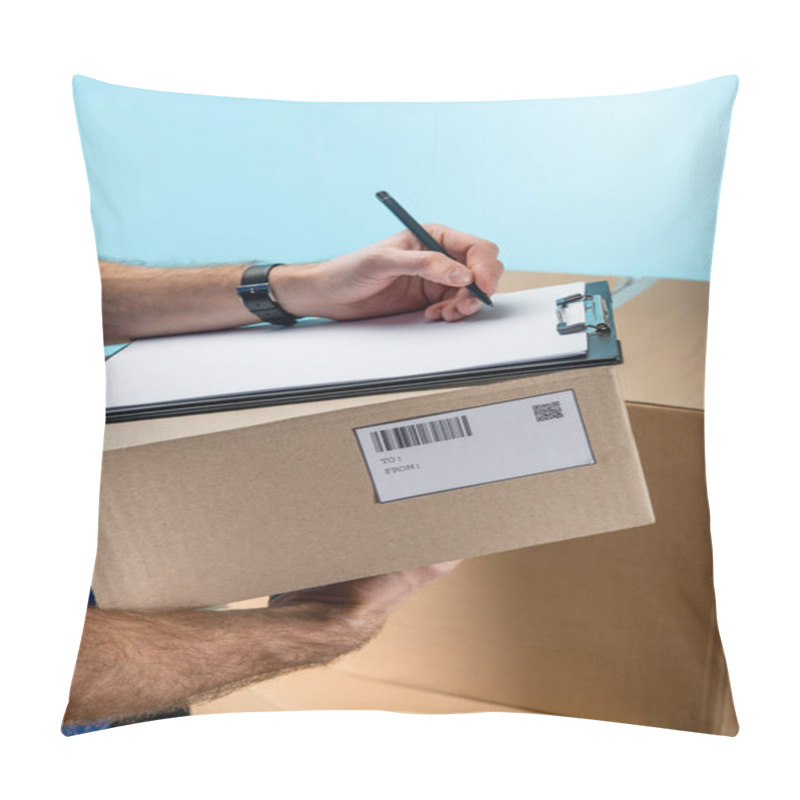 Personality  Cropped View Of Courier Writing On Clipboard With Cardboard Packages Isolated On Blue Pillow Covers