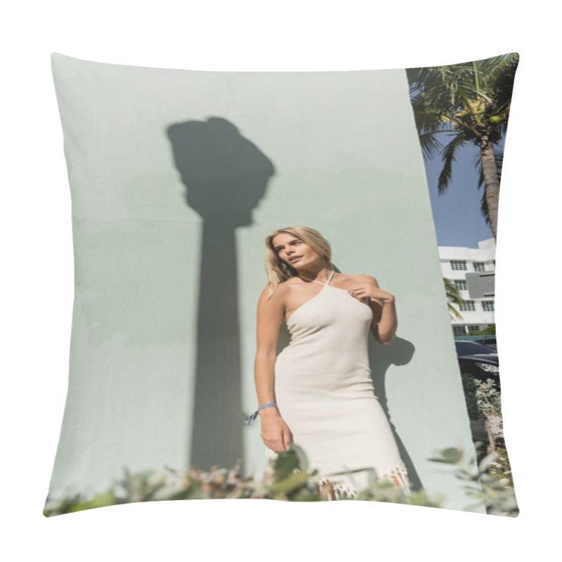 Personality  A Stunning Young Blonde Woman In A White Dress Stands Gracefully Next To A Vibrant Palm Tree In Miami. Pillow Covers