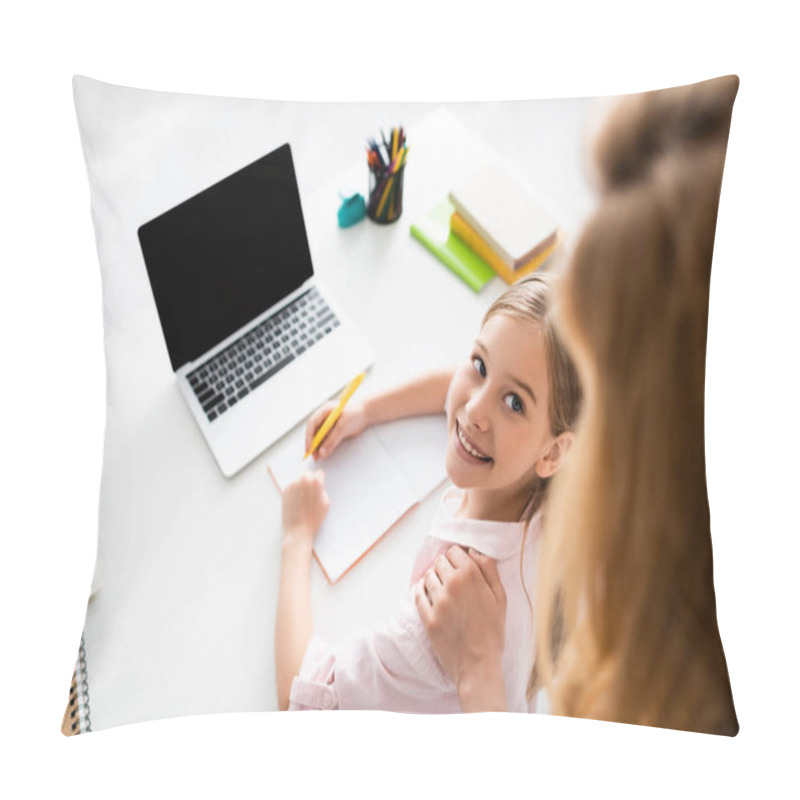 Personality  Overhead View Of Smiling Kid Looking At Mother While Writing On Notebook Near Laptop On Table  Pillow Covers