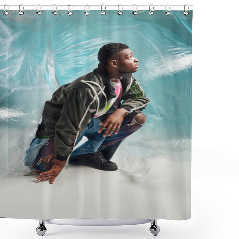 Personality  Side View Of Good Looking Afroamerican Man In Outwear Jacket With Led Stripes And Ripped Jeans Looking Up Near Glossy Cellophane On Turquoise Background, Creative Expression, DIY Clothing  Shower Curtains