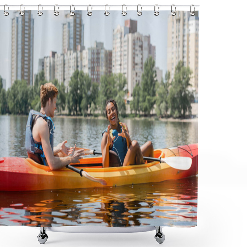 Personality  Cheerful African American Woman In Life Vest Gesturing Near Young Redhead Man And Having Fun In Sportive Kayak On Lake With Modern Buildings On Background Shower Curtains