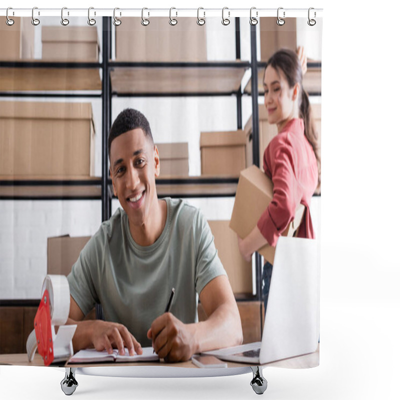 Personality  Smiling African American Online Web Store Owner Writing On Notebook Near Blurred Colleague With Boxes  Shower Curtains