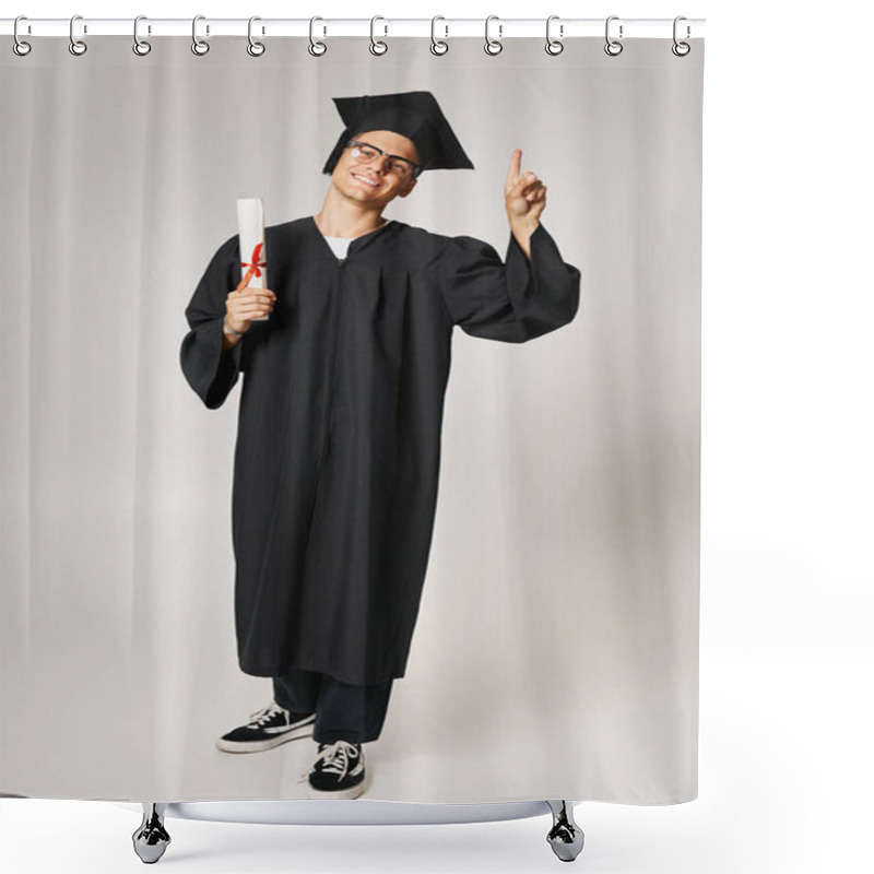 Personality  Cheerful Young Man In Graduate Outfit With Vision Glasses Pointing Finger To Up With Diploma In Hand Shower Curtains