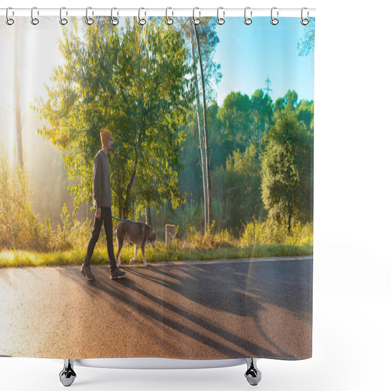 Personality  Young Handsome Man Walking His Dog In Nature With The Rays Of The Morning In Autumn. Friendship And Animal Love Concept. Sun, Warm Glow And Long Shadows. Shower Curtains