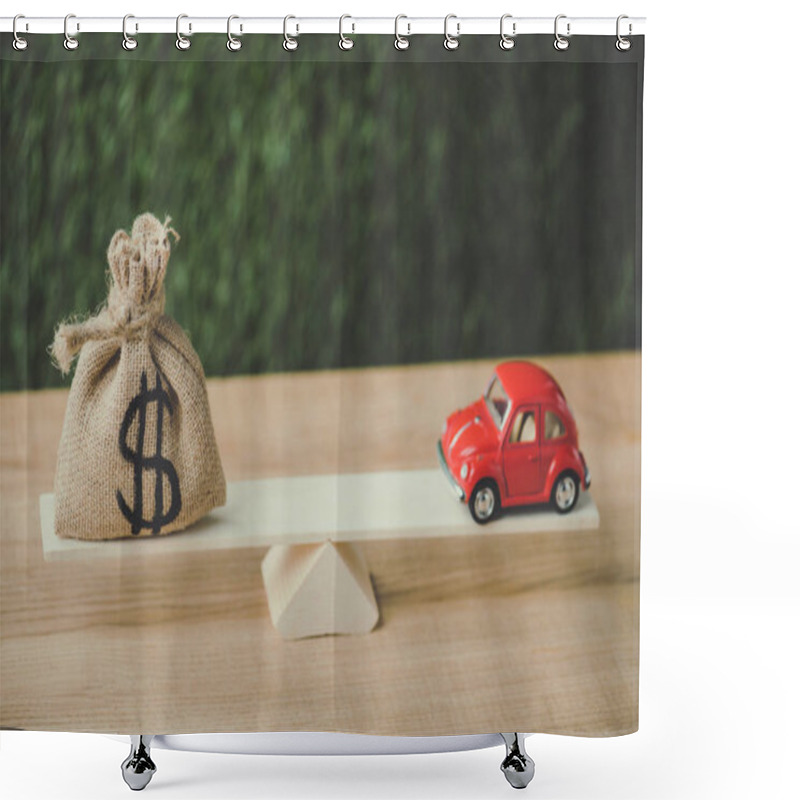 Personality  Red Miniature Car And Money Bag With Dollar Sign Balancing On Seesaw On Green Background Shower Curtains