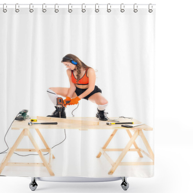 Personality  Seductive Girl In Protective Headphones Working With Electric Drill At Wooden Table With Tools, Isolated On White Shower Curtains