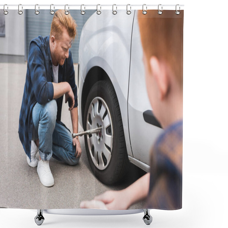 Personality  Father Changing Tire In Car With Wheel Wrench, Son Sitting Near Shower Curtains