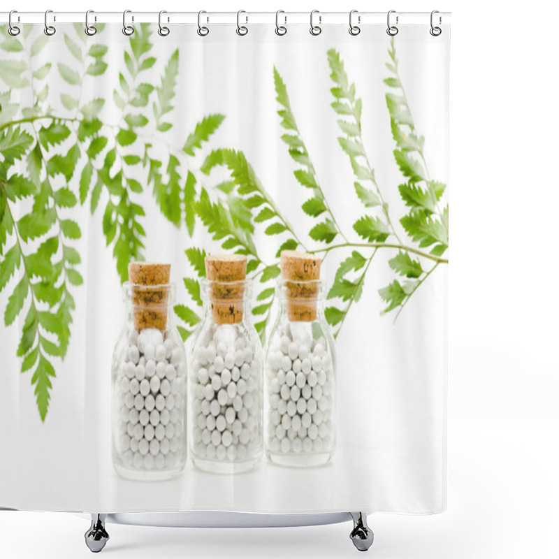 Personality  Selective Focus Of Small Pills In Glass Bottles With Wooden Corks Near Green Leaves On White  Shower Curtains