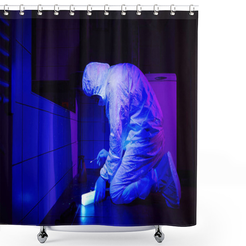 Personality  Criminologist Collecting DNA On Place Of Crime Under UV Light Shower Curtains