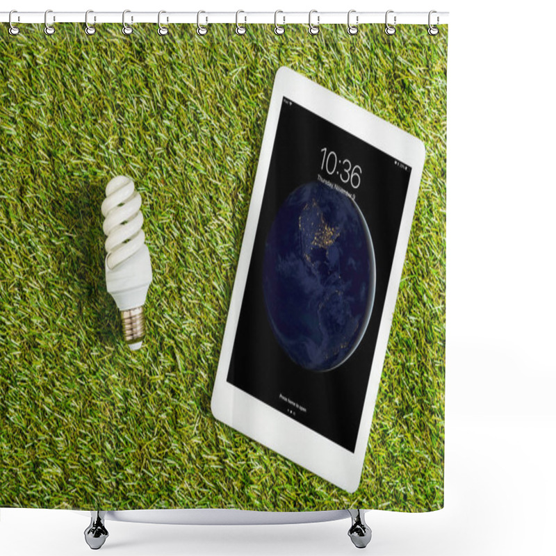 Personality  Top View Of Fluorescent Lamp Near Digital Tablet With Lock Screen On Green Grass, Energy Efficiency Concept Shower Curtains