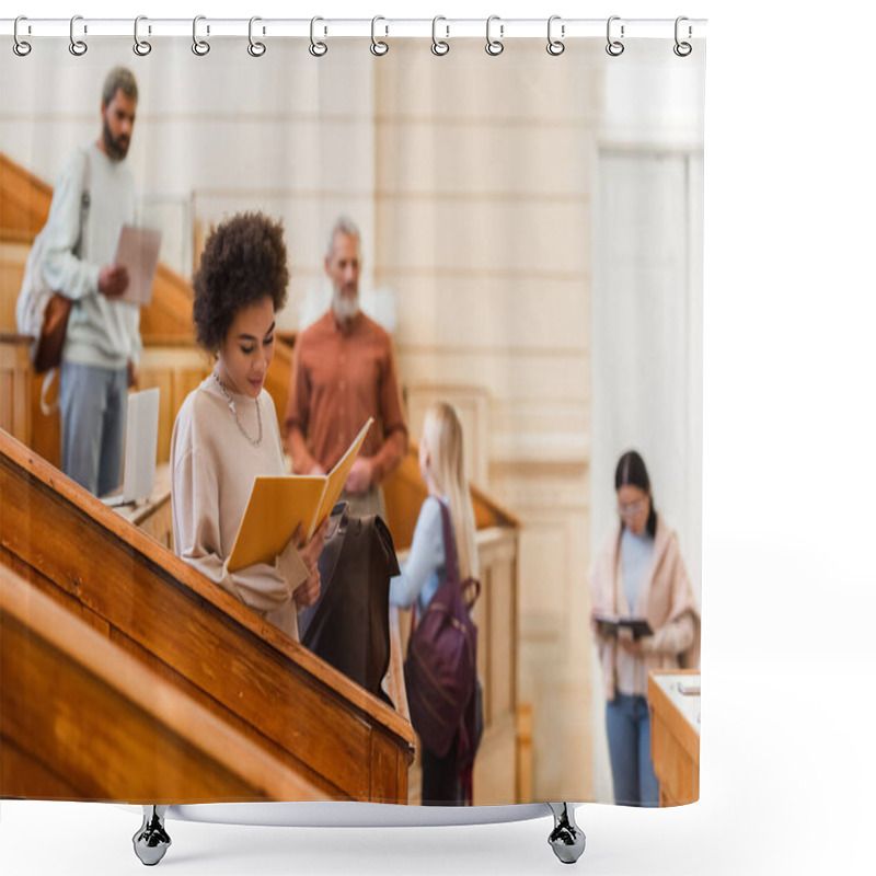 Personality  African American Student Looking At Notebook Near Blurred Friends And Teacher In University  Shower Curtains