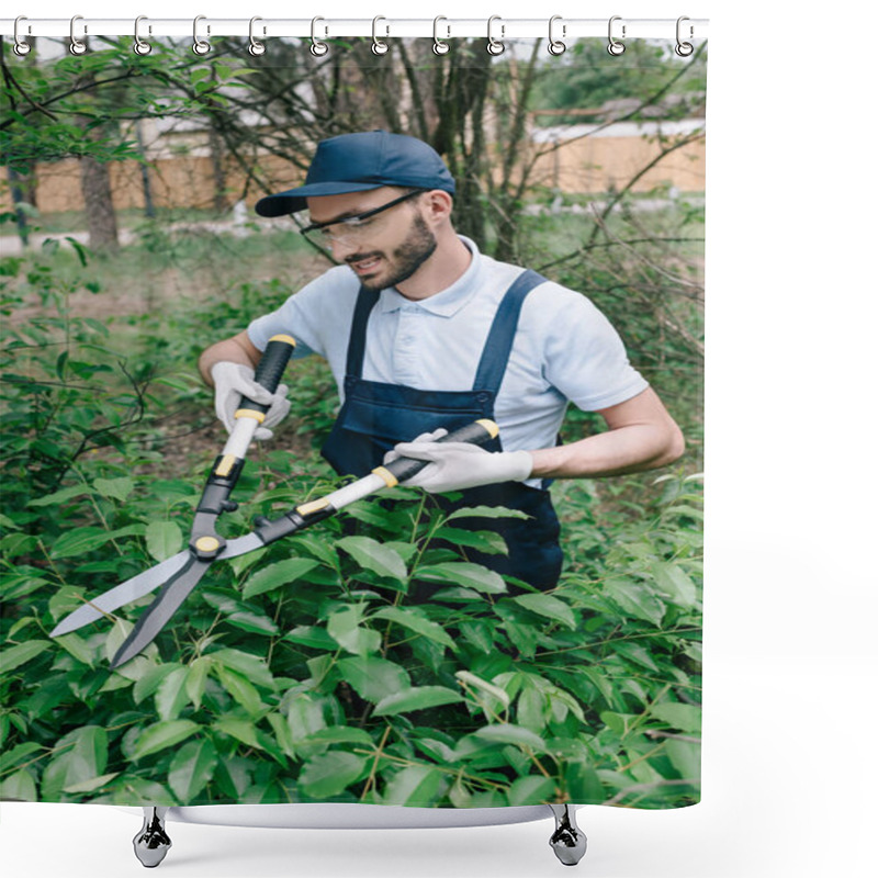 Personality  Smiling Gardener In Protective Glasses Trimming Bushes With Pruner In Park Shower Curtains