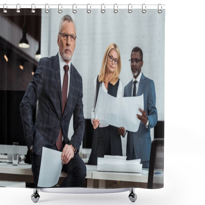 Personality  Selective Focus Of Thoughtful Businessman Holding Blank Paper Near Multicultural Partners Standing With Blueprints  Shower Curtains