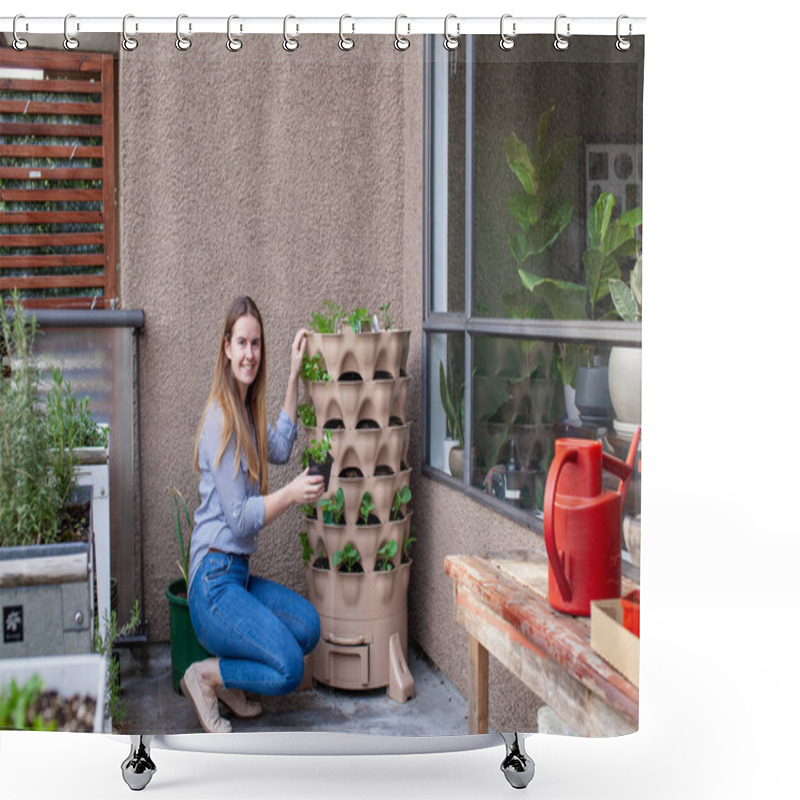 Personality  A Young Blonde Woman Is Planting A Vertical Tower Garden With Herbs And Vegetables On Her Apartment Patio, In The Early Spring. She Is Holding A Small Mint Starter, Deciding Where To Plant It.  Shower Curtains