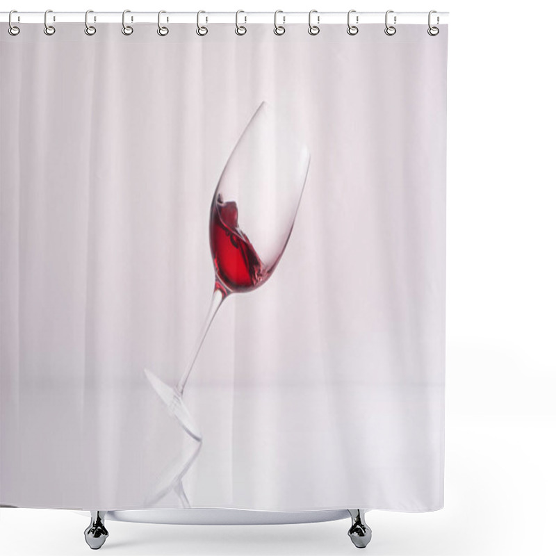 Personality  Inclined Glass With Red Wine On Reflective Surface And On White Shower Curtains