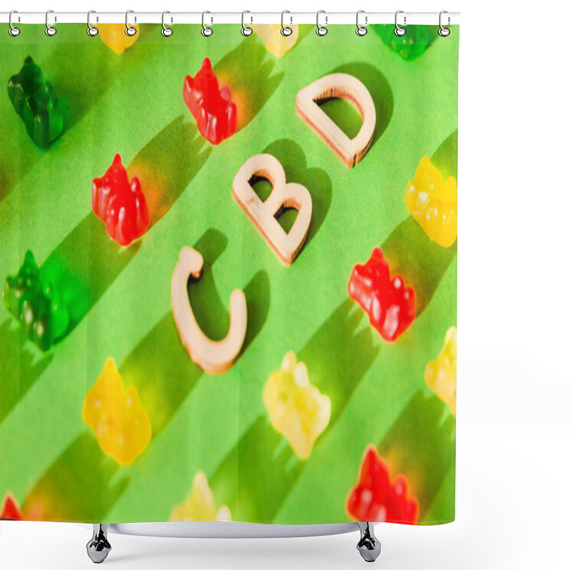 Personality  Wooden Letters CBD On A Green Background And Gelatin In The Form Of Bears. View From Above. The Shadow Of The Sun Falls On The Background Shower Curtains