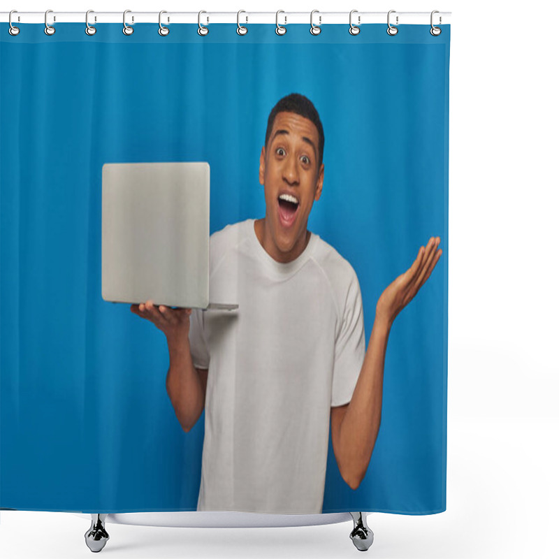 Personality  Excited African American Man Gesturing And Holding Laptop On Blue Background, Remote Work Concept Shower Curtains