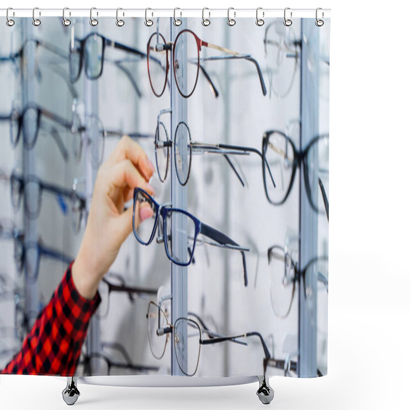 Personality  Woman's Hand Chooses Glasses. Presenting Spectacles. Row Of Glasses At An Opticians. Eyeglasses Shop. Stand With Glasses In The Store Of Optics. Shower Curtains