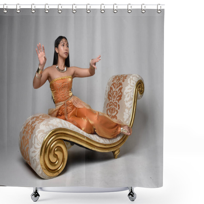 Personality  Full Length Portrait Of Pretty Young Asian Woman Wearing Golden Arabian Robes Like A Genie, Seated Pose On Lounge, Isolated On Studio Background. Shower Curtains