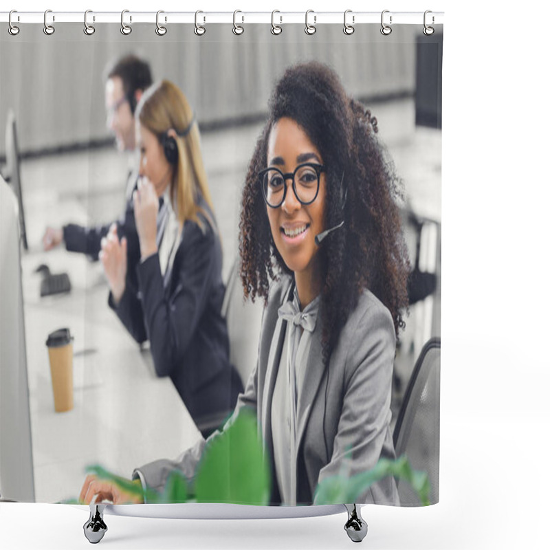 Personality  Attractive Young African American Woman In Headset Smiling At Camera While Working With Colleagues In Office  Shower Curtains