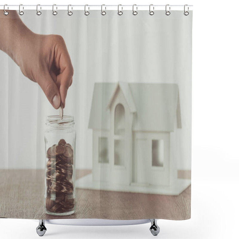 Personality  Cropped Image Of Man Putting Coin Into Glass Jar With Small House On Table, Saving Concept Shower Curtains