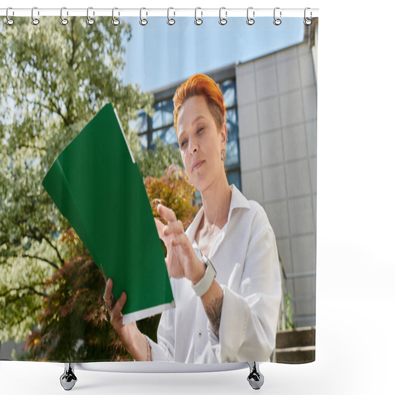 Personality  A Woman With Short Red Hair Reviews Notes On A Green Folder While Standing Outdoors On Campus. Shower Curtains