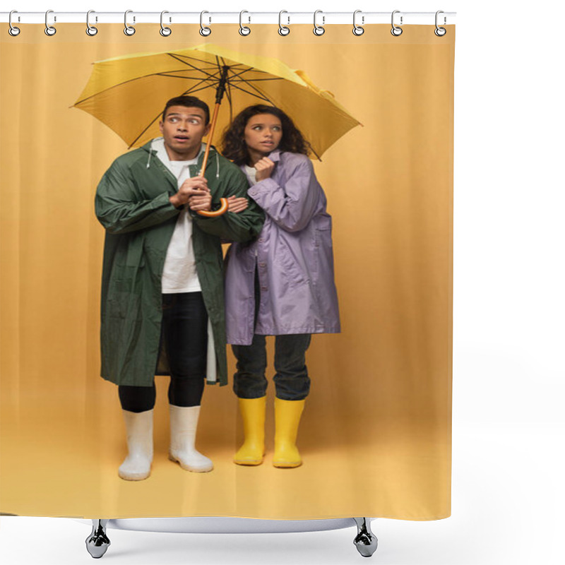 Personality  Scared Interracial Couple In Raincoats And Rubber Boots Holding Umbrella On Yellow Background Shower Curtains