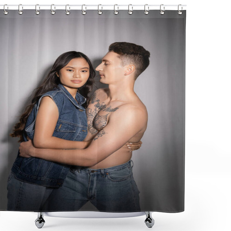 Personality  Brunette Asian Woman In Denim Vest Looking At Camera Near Muscular Tattooed Man On Grey Background Shower Curtains