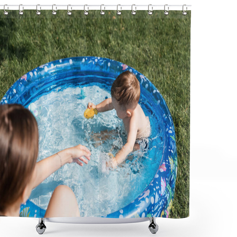 Personality  High Angle View Of Toddler Boy Playing With Rubber Toys In Inflatable Pool Near Blurred Mother  Shower Curtains